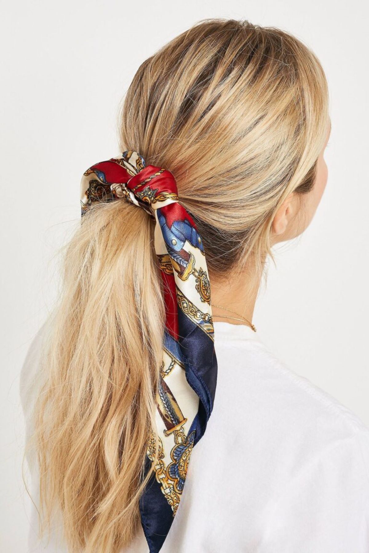 Tie your hair in a ponytail with a silk scarf